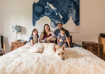 Newborn Lifestyle Photo Session. White Shepard dog on the bed with his family. Owen Sound Pet Photographer