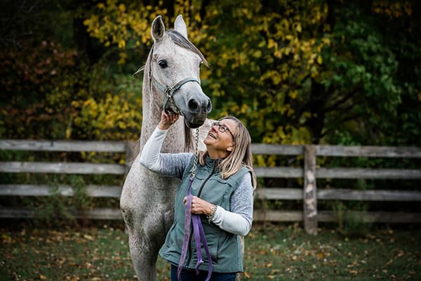 A woman with her Arabian Horse in the paddock in Markdale. Owen Sound Equine photographer horse photographer equine photography